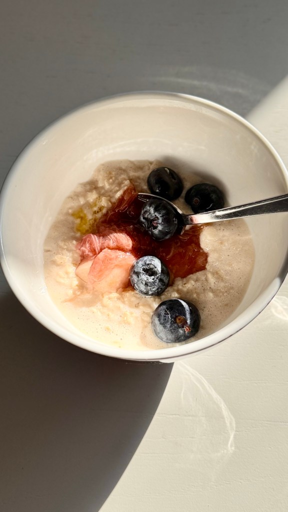 A bowl of stovetop oats with rhubarb, apple and blueberries